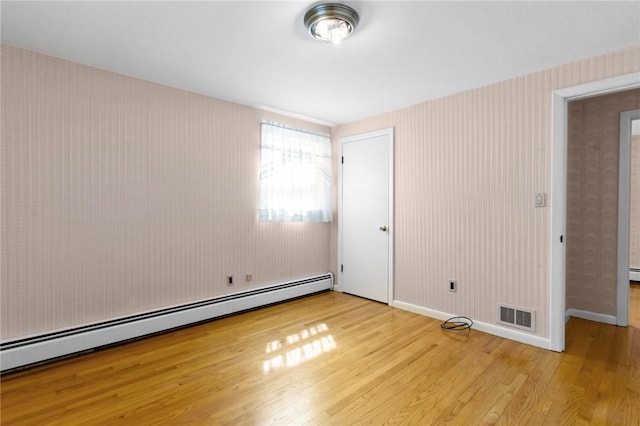 33 Limestone St, Warwick, RI 02889 - spare room featuring baseboard heating, light wood-style floors, and wallpapered walls