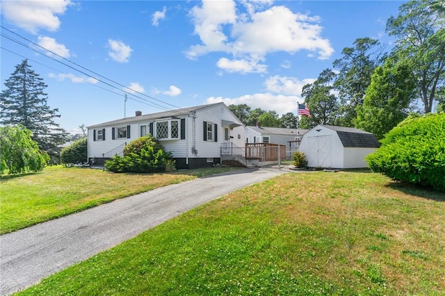 33 Limestone St, Warwick, RI 02889 - view of front of home with a storage unit and a front yard