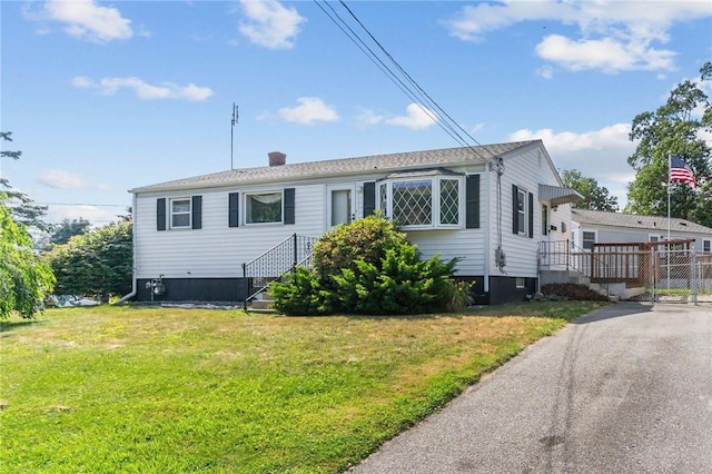 33 Limestone St, Warwick, RI 02889 - view of front of house with a front yard, a chimney, and asphalt driveway