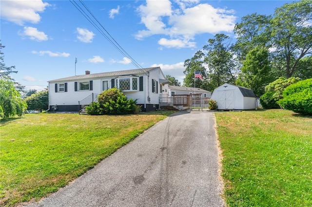 33 Limestone St, Warwick, RI 02889 - view of front of property with a storage unit and a front yard