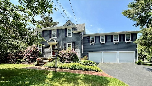 303 Washington Rd, Barrington, RI 02806 - colonial house featuring a garage, asphalt driveway, and a front yard