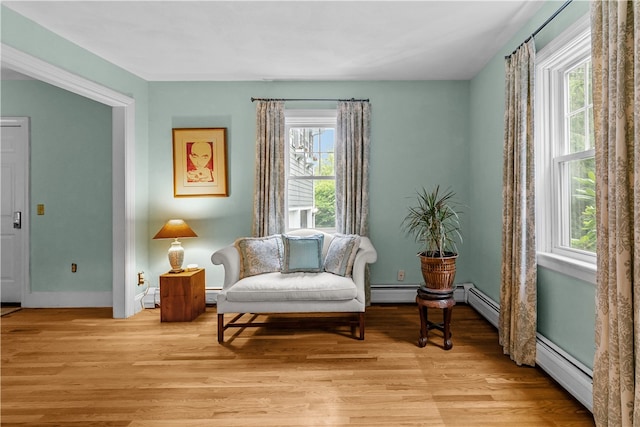 303 Washington Rd, Barrington, RI 02806 - sitting room featuring a baseboard heating unit, healthy amount of natural light, and light wood-type flooring