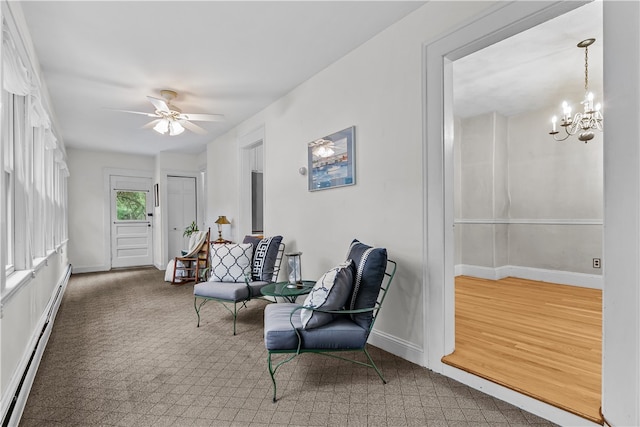 303 Washington Rd, Barrington, RI 02806 - living area featuring a baseboard heating unit, a chandelier, and ceiling fan