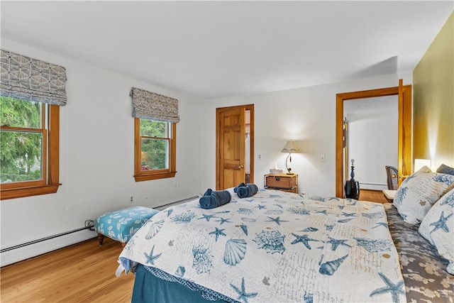 303 Washington Rd, Barrington, RI 02806 - bedroom with light wood-type flooring, a baseboard heating unit, and a baseboard radiator