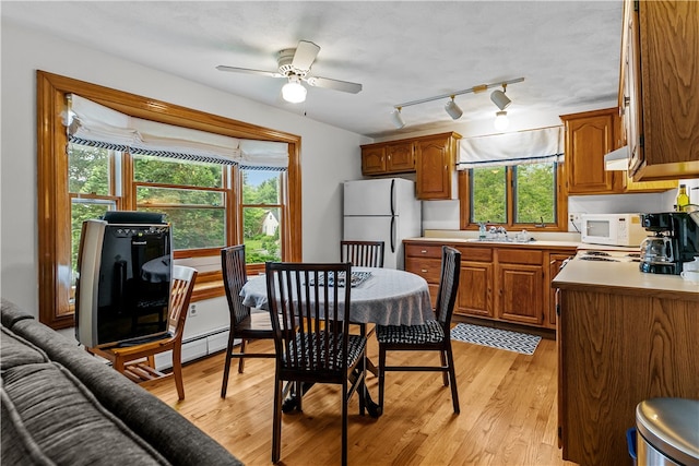 303 Washington Rd, Barrington, RI 02806 - kitchen with white appliances, brown cabinetry, light wood finished floors, and ceiling fan