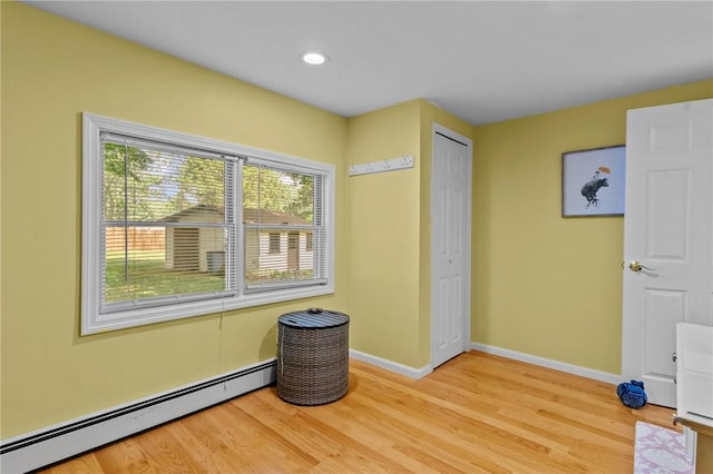 37 Ridge Rd, East Greenwich, RI 02818 - unfurnished bedroom with a baseboard heating unit, light wood-type flooring, recessed lighting, and a closet