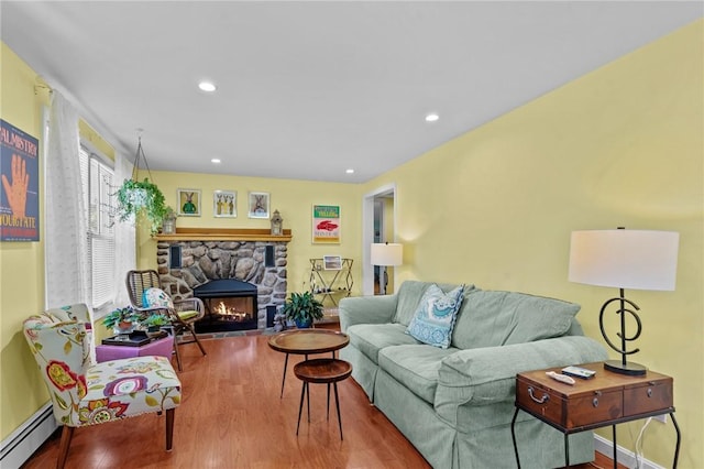 37 Ridge Rd, East Greenwich, RI 02818 - living area featuring a baseboard radiator, wood finished floors, a stone fireplace, and recessed lighting