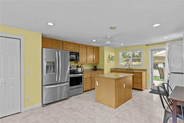 37 Ridge Rd, East Greenwich, RI 02818 - kitchen with stainless steel appliances, light countertops, a center island, recessed lighting, and ceiling fan