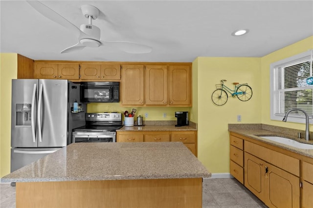 37 Ridge Rd, East Greenwich, RI 02818 - kitchen featuring stainless steel appliances, a center island, light stone counters, light tile patterned floors, and a ceiling fan
