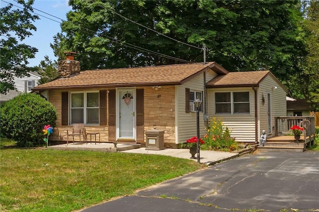 37 Ridge Rd, East Greenwich, RI 02818 - view of front of property with stone siding, a front lawn, a chimney, and covered porch