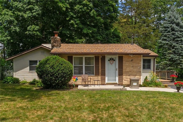 37 Ridge Rd, East Greenwich, RI 02818 - view of front of house featuring a front lawn, stone siding, and a chimney