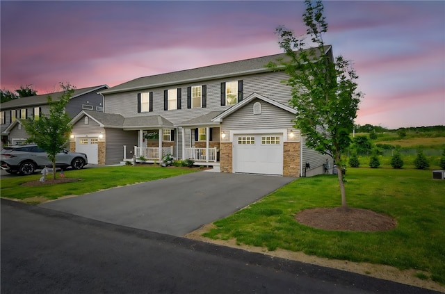 2 Sydney Rose Ct Unit B, Johnston, RI 02919 - view of front of property with asphalt driveway, covered porch, a yard, and a garage