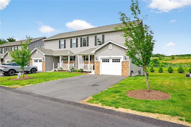 2 Sydney Rose Ct Unit B, Johnston, RI 02919 - view of front of home with covered porch, driveway, a front yard, and a garage