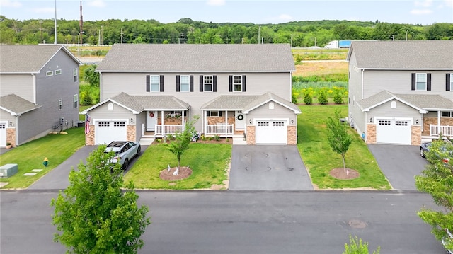 2 Sydney Rose Ct Unit B, Johnston, RI 02919 - view of front of house featuring a porch, asphalt driveway, a front lawn, and stone siding
