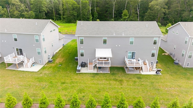 2 Sydney Rose Ct Unit B, Johnston, RI 02919 - rear view of house with stairs, a wooden deck, a patio, and a lawn