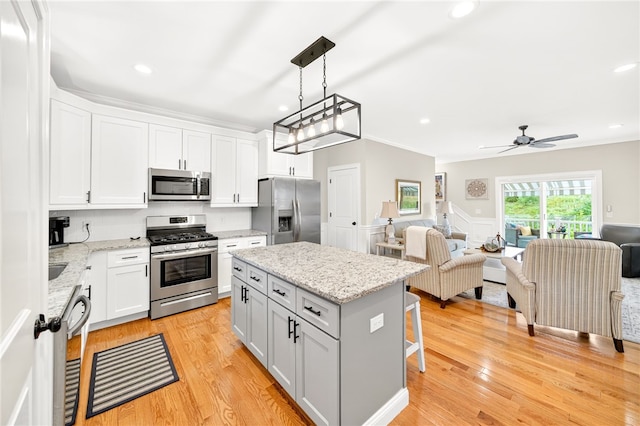 2 Sydney Rose Ct Unit B, Johnston, RI 02919 - kitchen featuring appliances with stainless steel finishes, open floor plan, a center island, a kitchen bar, and recessed lighting