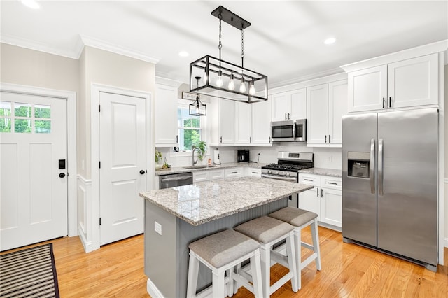 2 Sydney Rose Ct Unit B, Johnston, RI 02919 - kitchen with stainless steel appliances, crown molding, plenty of natural light, white cabinetry, and recessed lighting