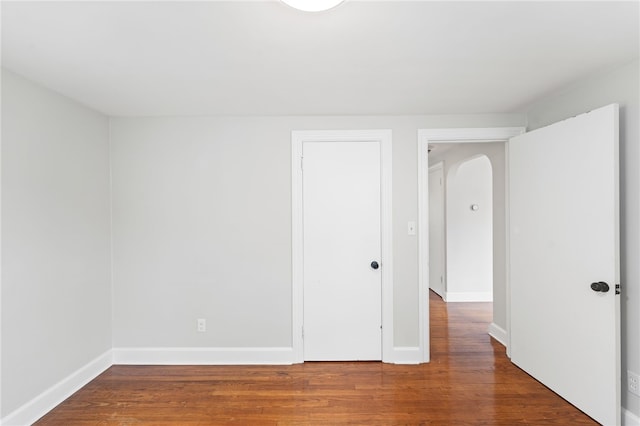 32 Rosemere Dr, East Providence, RI 02914 - unfurnished bedroom featuring wood finished floors, a closet, and arched walkways