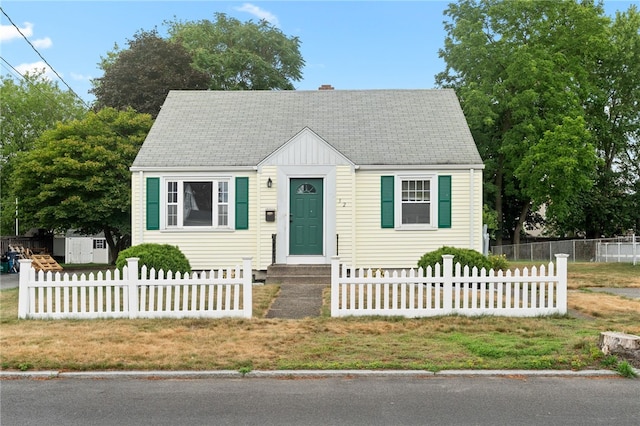 32 Rosemere Dr, East Providence, RI 02914 - view of front facade with roof with shingles, a storage unit, and a chimney