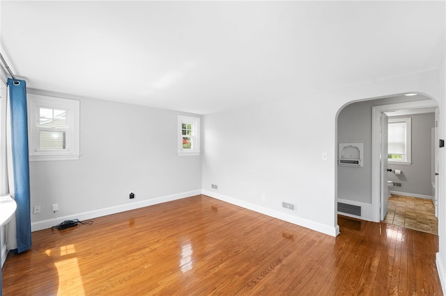 32 Rosemere Dr, East Providence, RI 02914 - empty room with arched walkways and wood-type flooring