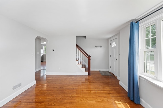 32 Rosemere Dr, East Providence, RI 02914 - foyer entrance featuring arched walkways, plenty of natural light, stairway, and light wood-style floors