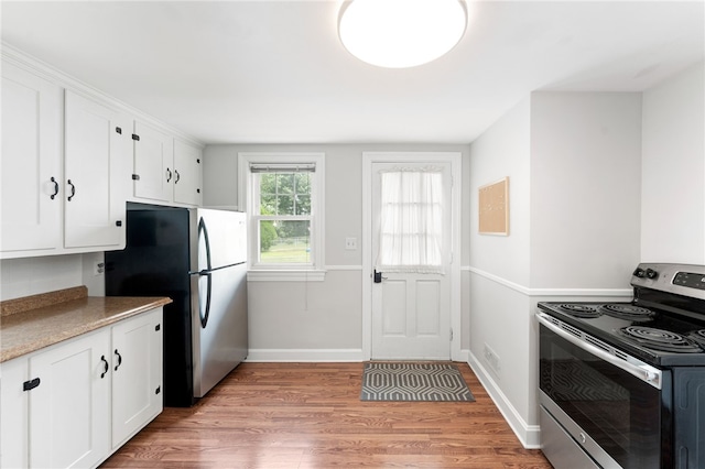 32 Rosemere Dr, East Providence, RI 02914 - kitchen featuring appliances with stainless steel finishes, white cabinets, light wood finished floors, and light countertops