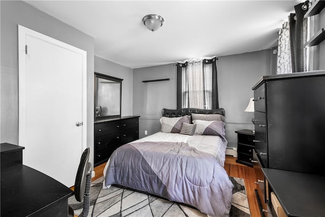 7 Snell Ct, West Warwick, RI 02893 - bedroom featuring wood finished floors and a baseboard heating unit
