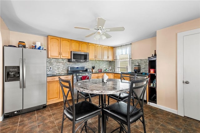 7 Snell Ct, West Warwick, RI 02893 - kitchen with appliances with stainless steel finishes, light brown cabinets, decorative backsplash, ceiling fan, and dark countertops