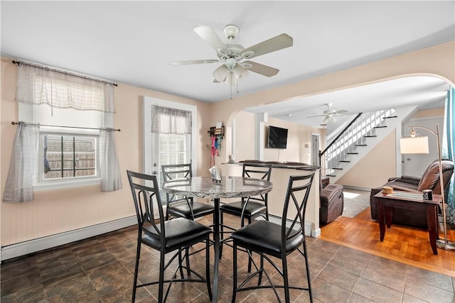 7 Snell Ct, West Warwick, RI 02893 - dining space with arched walkways, a baseboard radiator, stairs, and ceiling fan