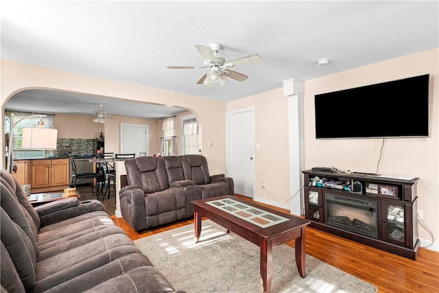 7 Snell Ct, West Warwick, RI 02893 - living room with arched walkways, a ceiling fan, and light wood finished floors