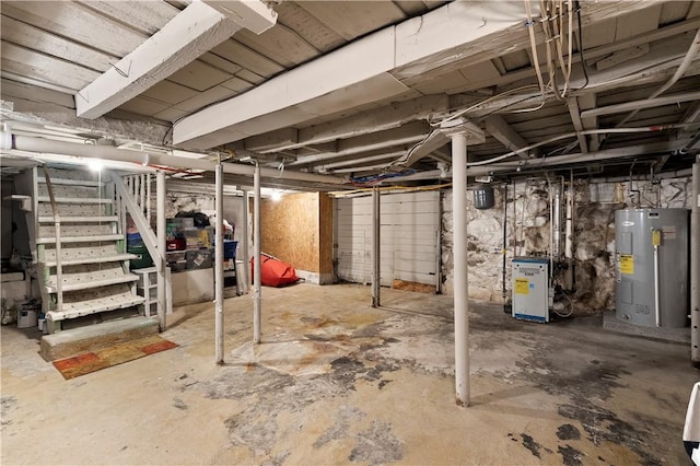 7 Snell Ct, West Warwick, RI 02893 - unfinished basement with electric water heater, stairway, and a heating unit