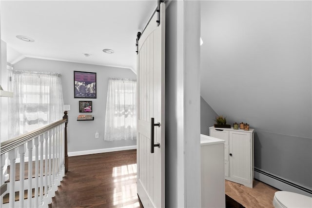 7 Snell Ct, West Warwick, RI 02893 - hallway featuring a baseboard radiator, a barn door, vaulted ceiling, wood finished floors, and an upstairs landing