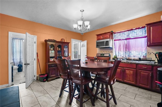 19 Covell St, Providence, RI 02909 - dining room with a chandelier and light tile patterned floors