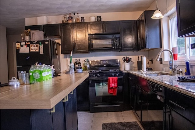 2 Main St Unit 21, Lincoln, RI 02802 - kitchen featuring black appliances, light tile patterned floors, decorative light fixtures, and a peninsula