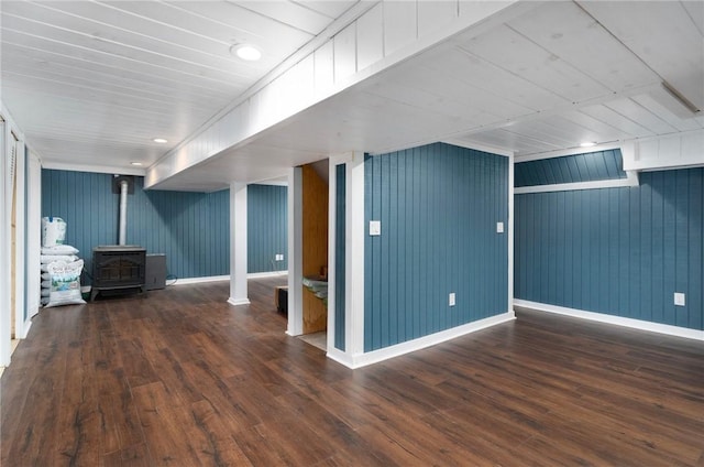 219 Fenner Hill Rd, Hopkinton, RI 02832 - below grade area featuring a wood stove, wood-type flooring, and wood walls
