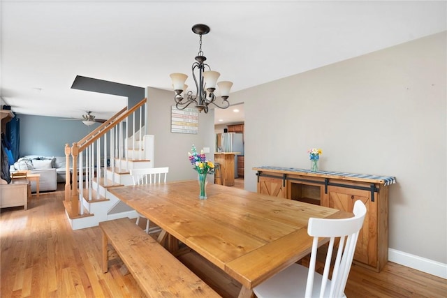 219 Fenner Hill Rd, Hopkinton, RI 02832 - dining space with stairs, light wood-style flooring, a chandelier, and ceiling fan
