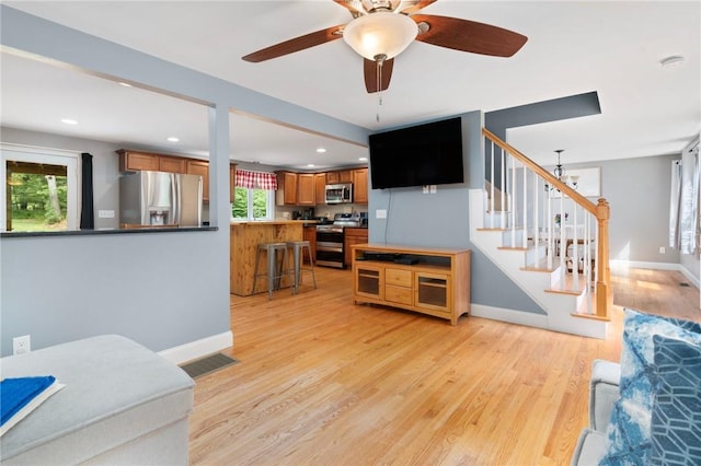 219 Fenner Hill Rd, Hopkinton, RI 02832 - living room featuring healthy amount of natural light, stairs, light wood-style floors, ceiling fan, and recessed lighting