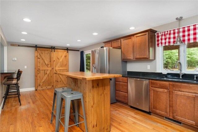 219 Fenner Hill Rd, Hopkinton, RI 02832 - kitchen featuring stainless steel appliances, butcher block counters, a kitchen bar, recessed lighting, and light wood-type flooring