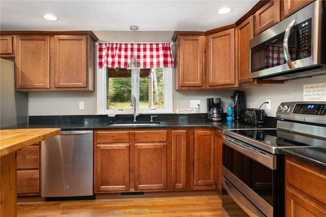 219 Fenner Hill Rd, Hopkinton, RI 02832 - kitchen featuring stainless steel appliances, brown cabinets, recessed lighting, and light wood-type flooring