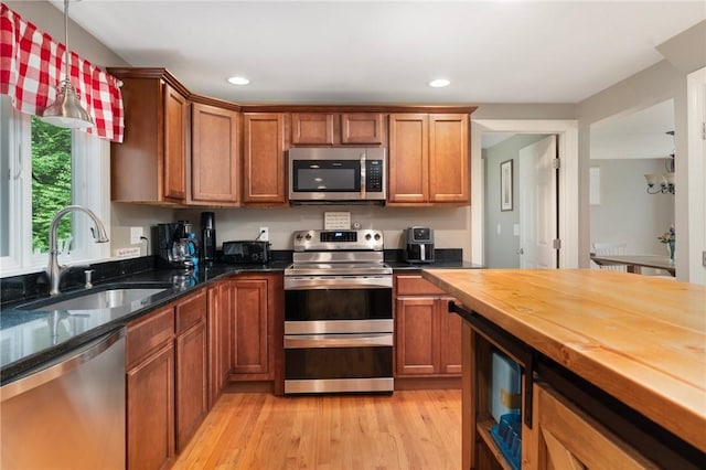 219 Fenner Hill Rd, Hopkinton, RI 02832 - kitchen with stainless steel appliances, butcher block countertops, light wood-style flooring, brown cabinets, and recessed lighting