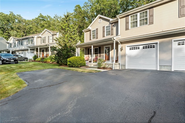 18 Country Hill Ln, Smithfield, RI 02917 - view of front of home featuring a porch, driveway, and a front lawn