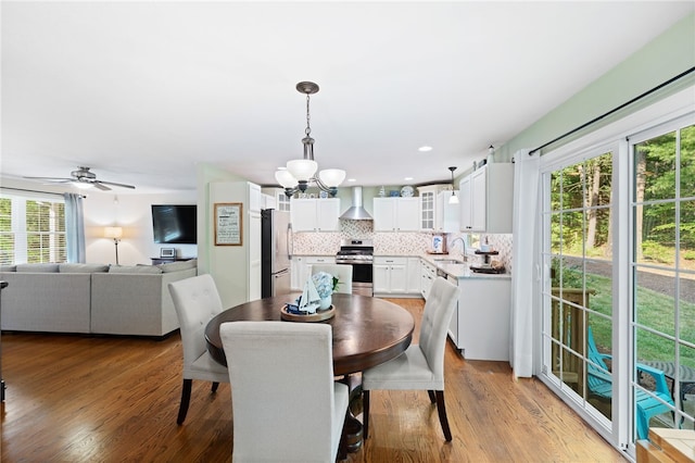 18 Country Hill Ln, Smithfield, RI 02917 - dining space featuring healthy amount of natural light, a chandelier, and wood finished floors