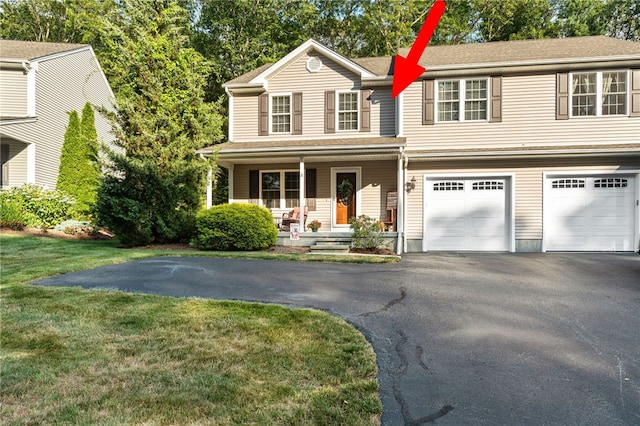 18 Country Hill Ln, Smithfield, RI 02917 - view of front facade with driveway, a porch, an attached garage, and a front yard