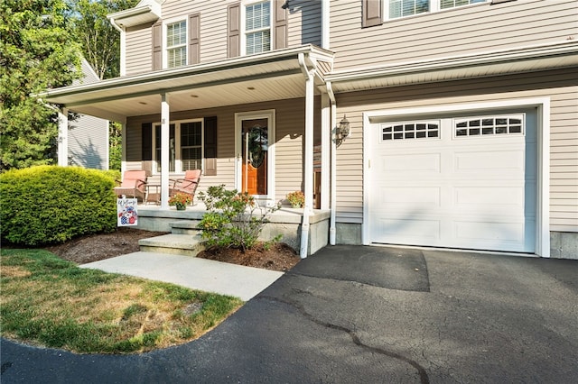 18 Country Hill Ln, Smithfield, RI 02917 - entrance to property with a porch, a garage, and asphalt driveway