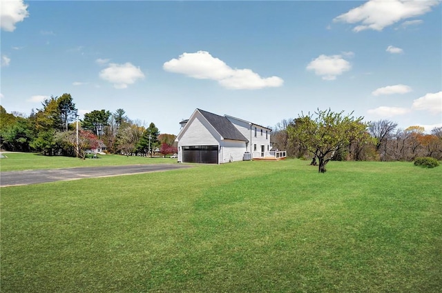 2 Winsor Rd, Scituate, RI 02857 - view of green lawn with driveway and a garage