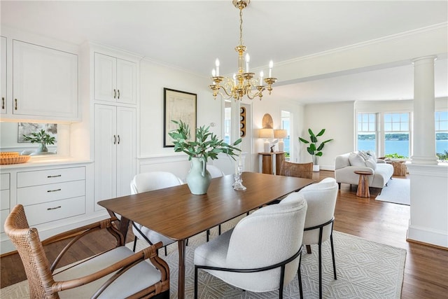 17 Ferolbink Way, Little Compton, RI 02837 - dining space featuring decorative columns, wood finished floors, a chandelier, and ornamental molding