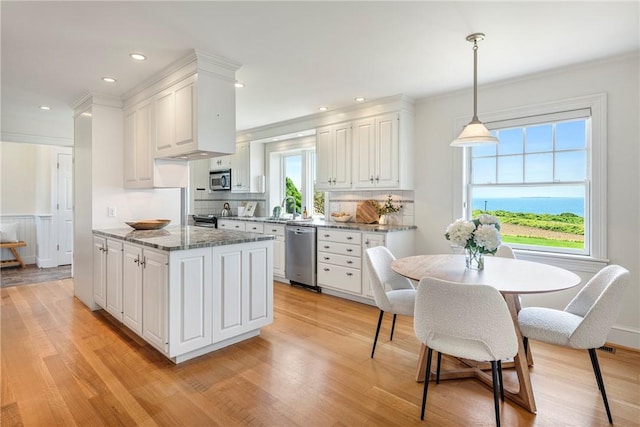 17 Ferolbink Way, Little Compton, RI 02837 - kitchen with appliances with stainless steel finishes, white cabinetry, light wood-style floors, crown molding, and hanging light fixtures