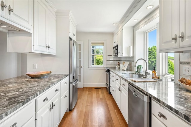 17 Ferolbink Way, Little Compton, RI 02837 - kitchen featuring stainless steel appliances, white cabinetry, light wood finished floors, dark stone countertops, and recessed lighting