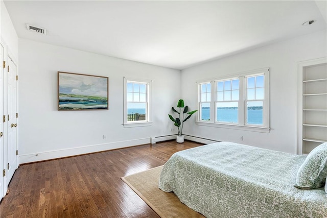 17 Ferolbink Way, Little Compton, RI 02837 - bedroom featuring dark wood finished floors and a baseboard heating unit