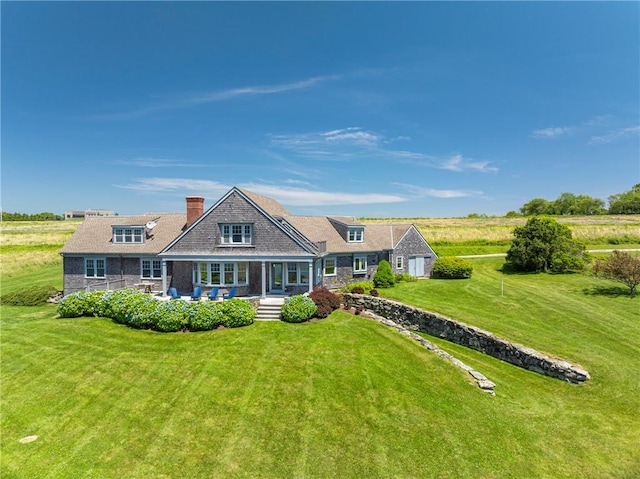 17 Ferolbink Way, Little Compton, RI 02837 - rear view of house with covered porch, a chimney, a lawn, and a garage